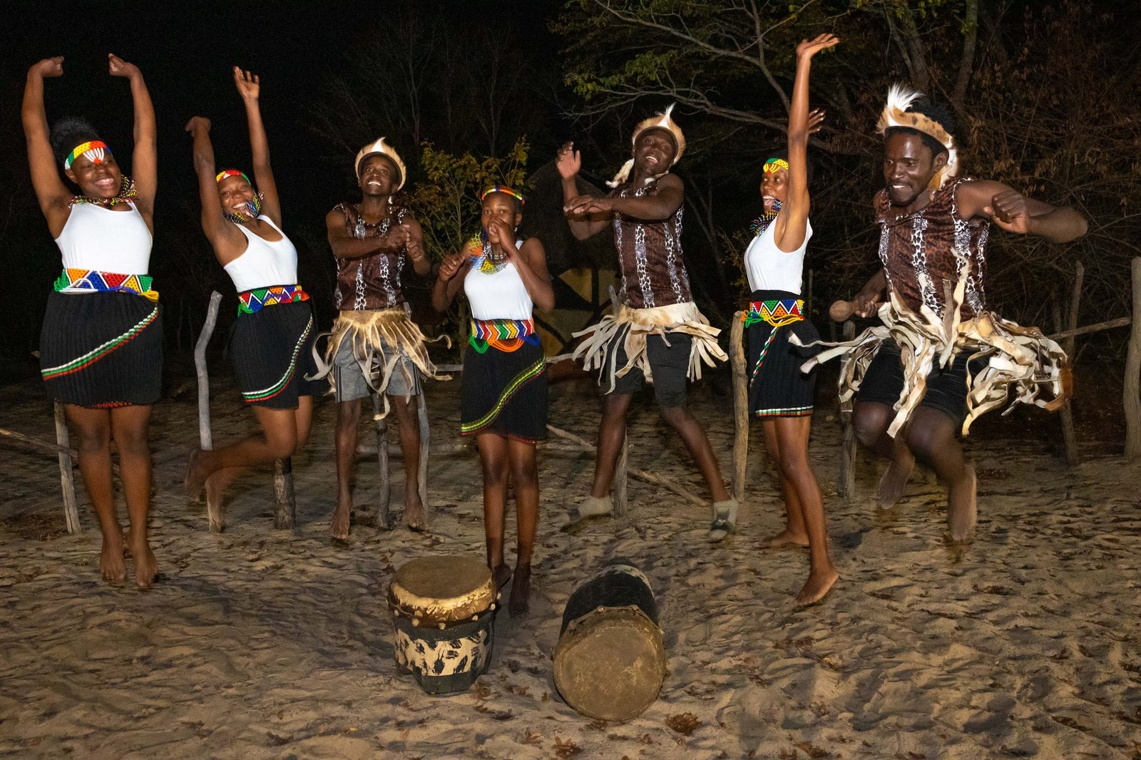 Dancers and drummers in traditional dress perform at night at Gwango Heritage Resort