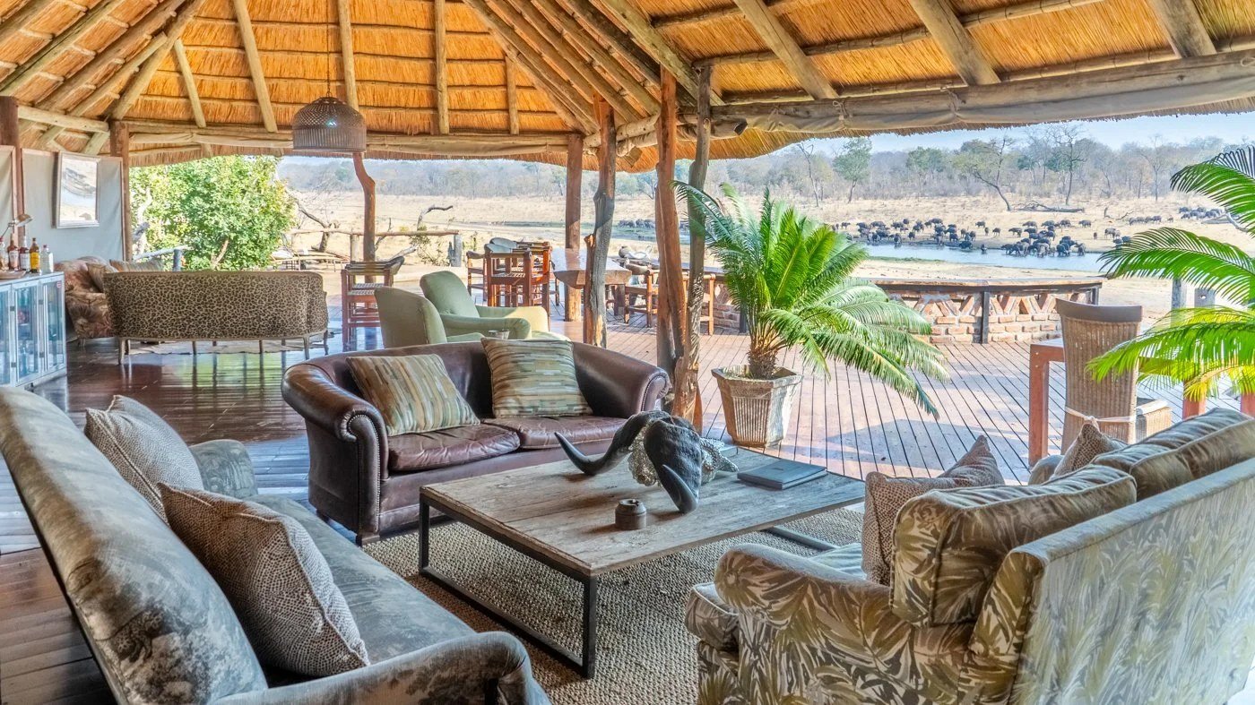 Khulu Bush Camp's lounge sits under thatch, open to the deck and the pan beyond