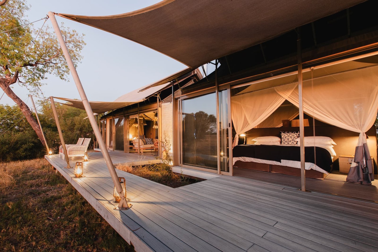 A suite's private deck at Wilderness Linkwasha has loungers under a sweeping canvas roof