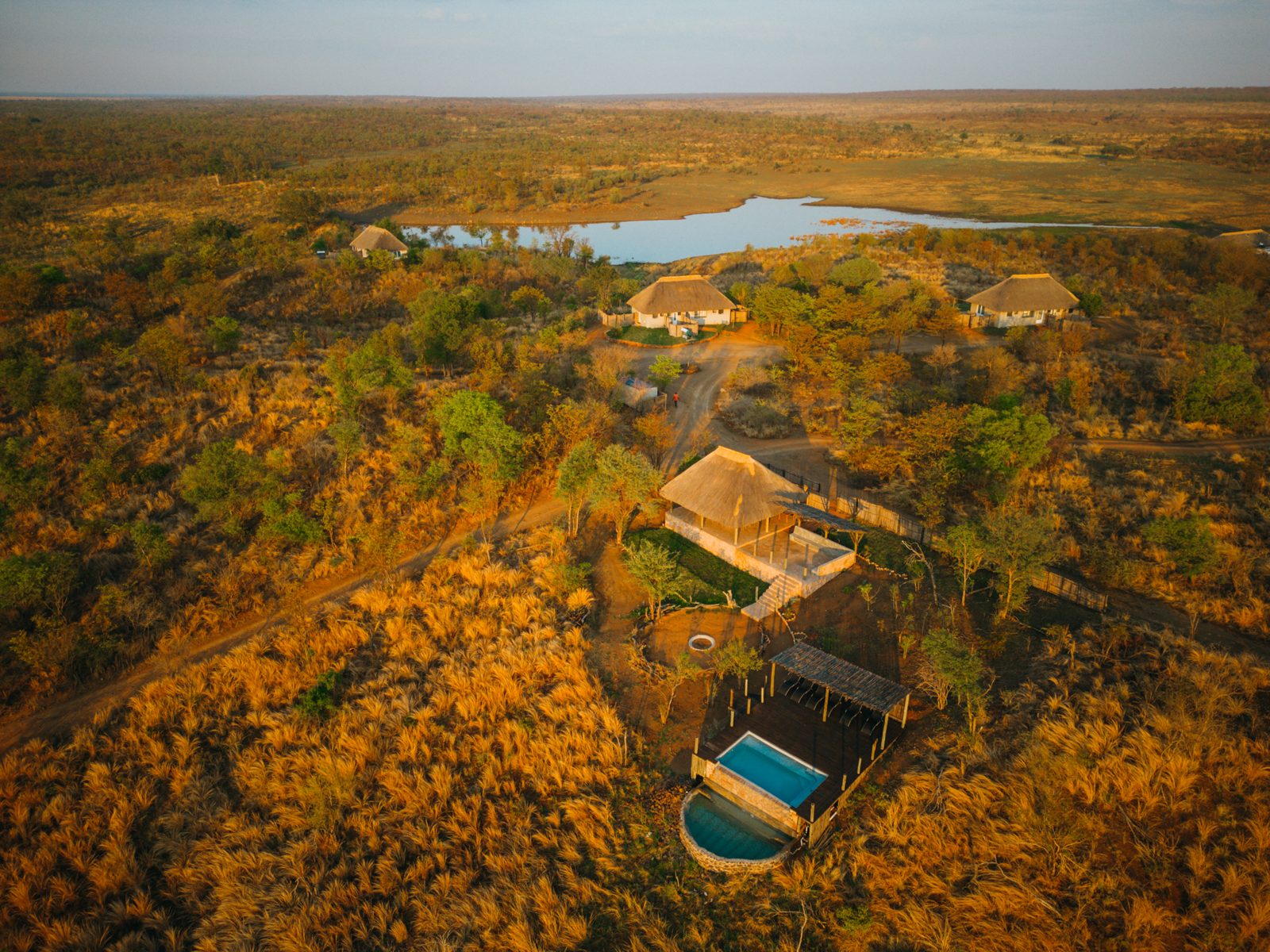The lodge from the air, with the dam behind it