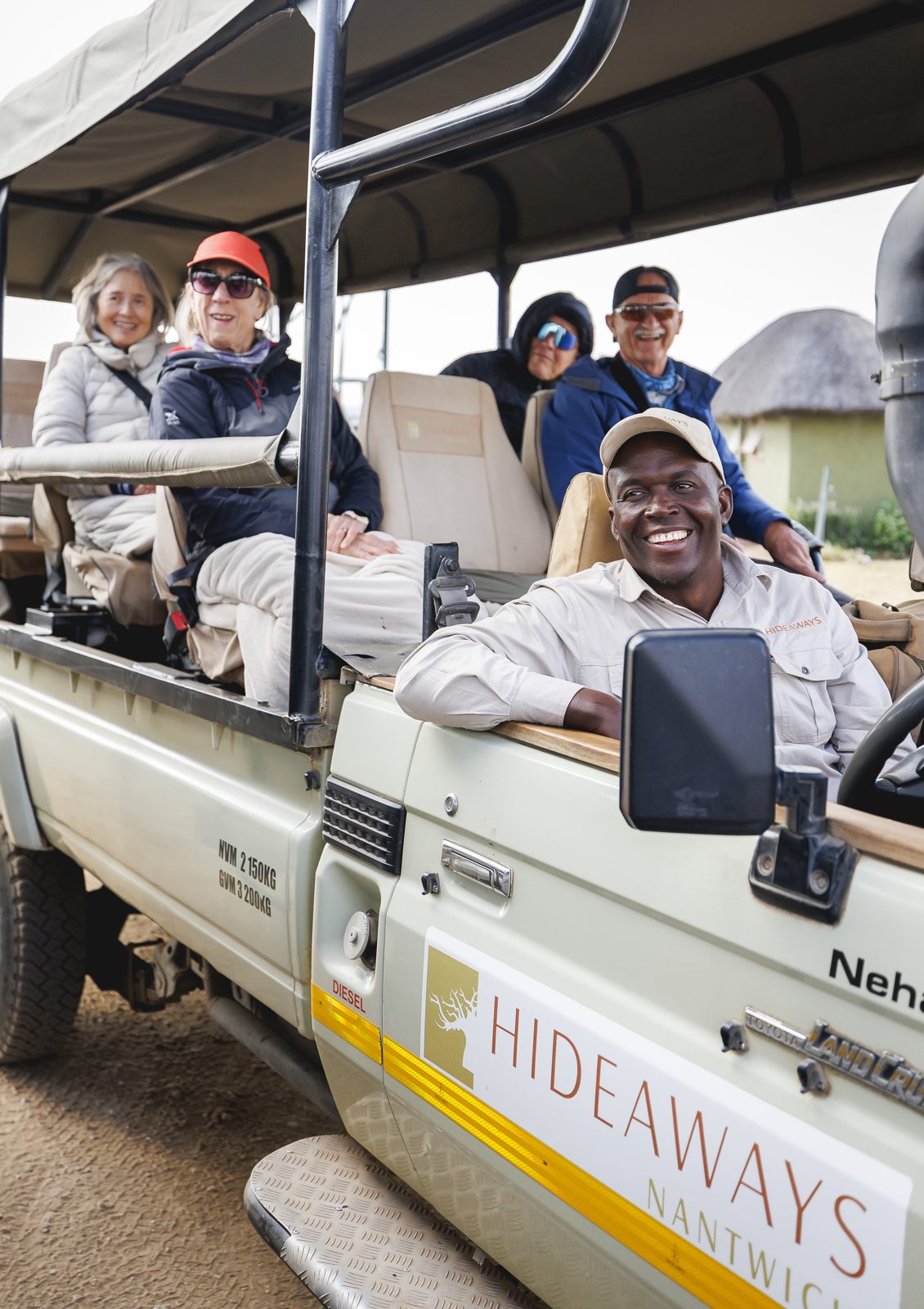 Guests and their guide in one of the lodge's open Land Cruisers
