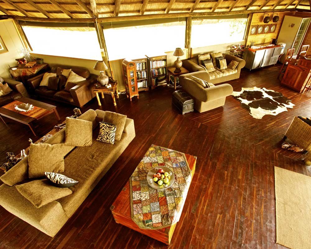 Nehimba Lodge's main lounge has leather sofas and a wide view out front
