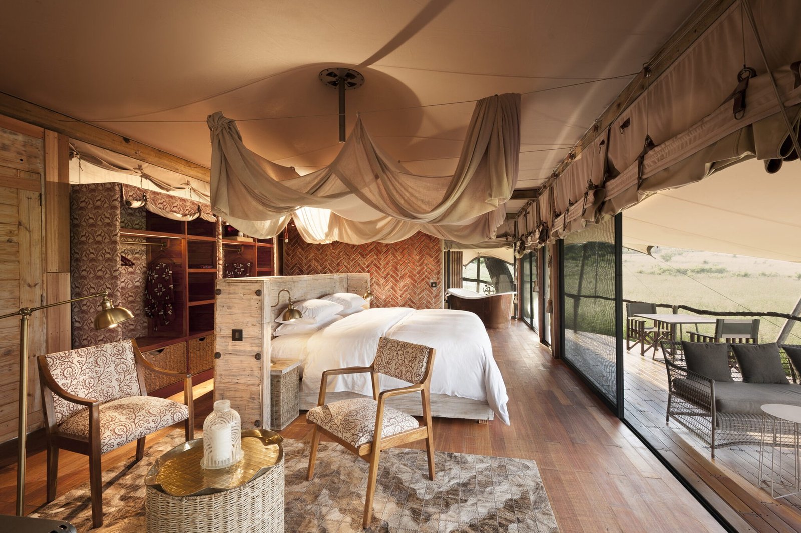 A tented suite at Somalisa Camp has a canopy bed and glass doors to the deck