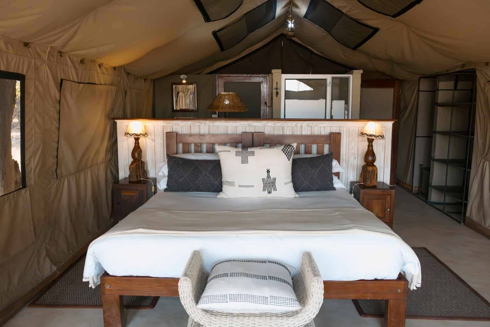 A tented suite at The Hide Safari Camp has a double bed under the canvas roof