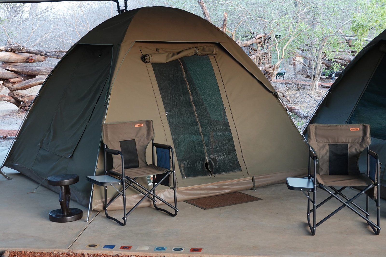 A dome tent at The Siding has two camp chairs on its front step