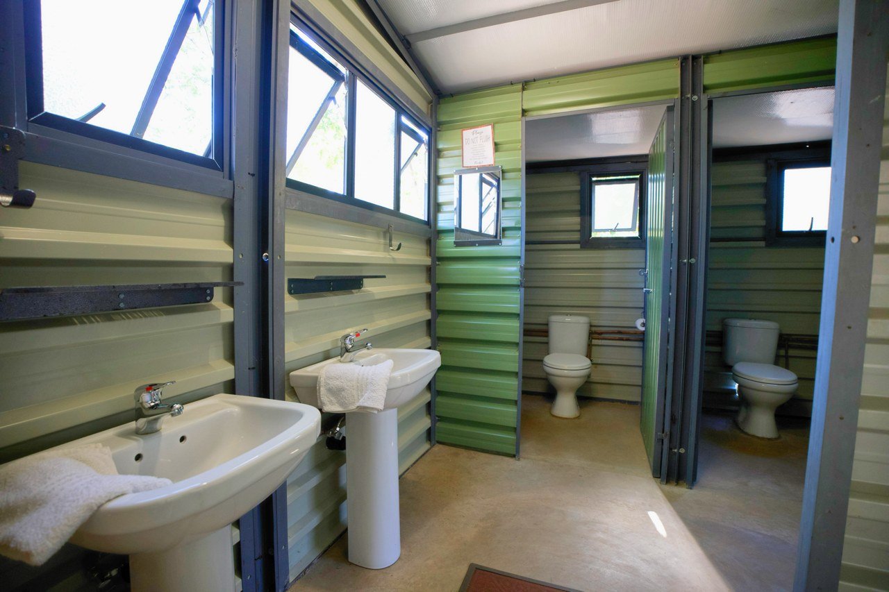 The Siding's bathroom block has basins and toilets behind green walls